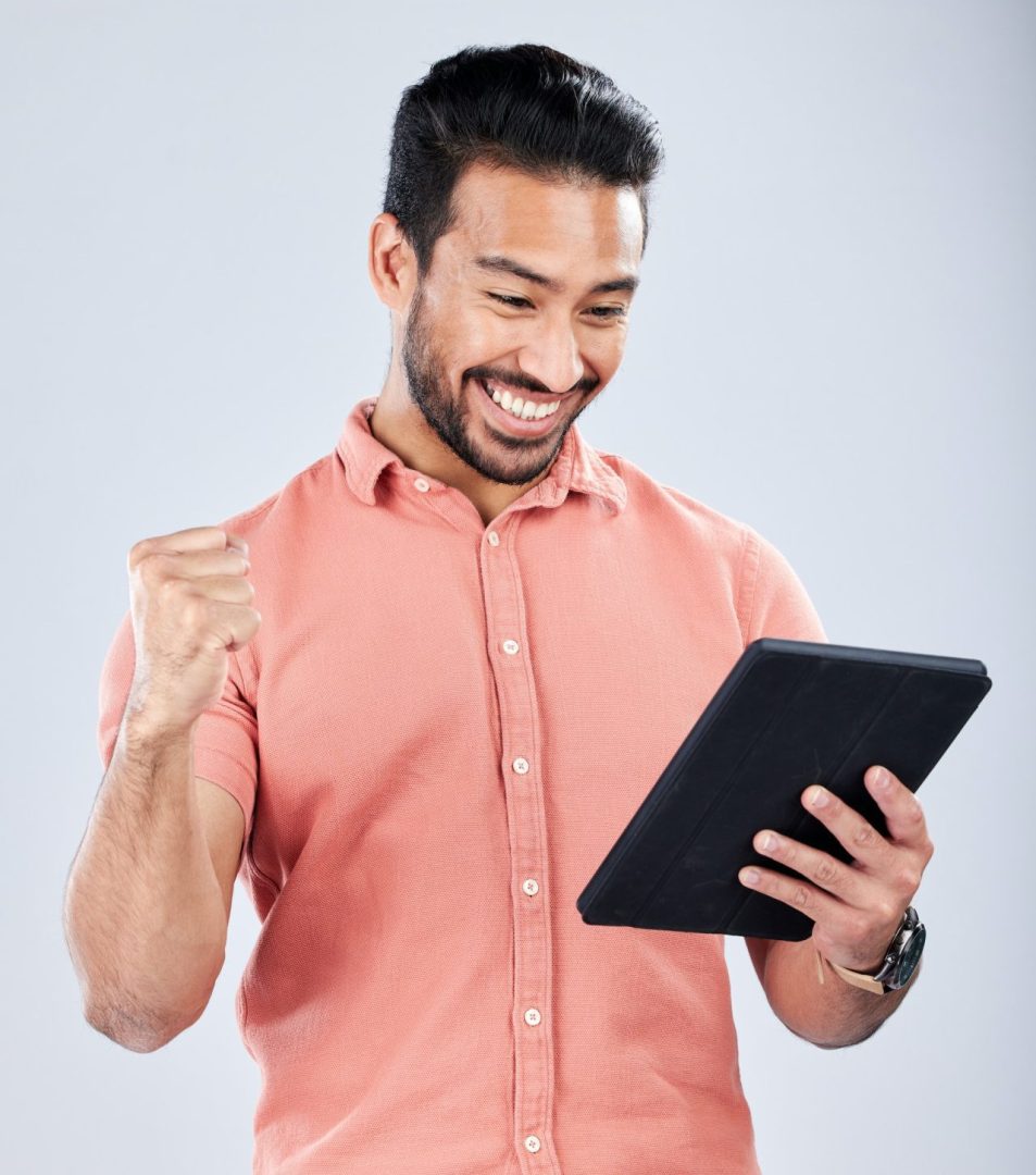 Happy asian man, tablet or success fist on isolated studio background for financial growth, stock m